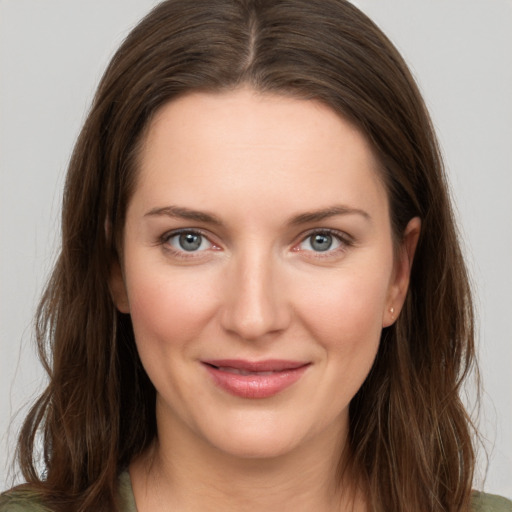 Joyful white young-adult female with long  brown hair and grey eyes