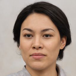 Joyful asian young-adult female with medium  brown hair and brown eyes