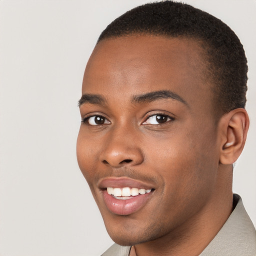 Joyful black young-adult male with short  brown hair and brown eyes