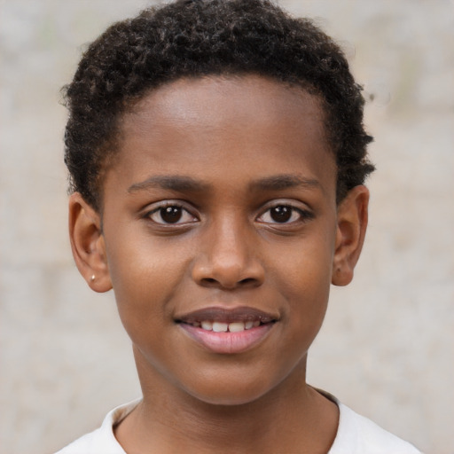 Joyful black child male with short  brown hair and brown eyes