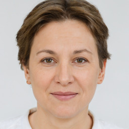 Joyful white adult female with short  brown hair and brown eyes