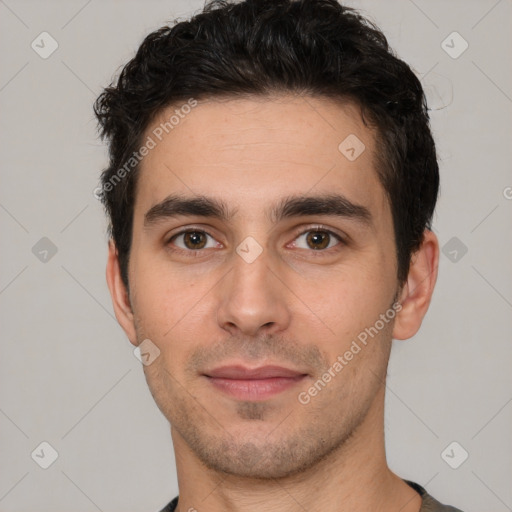 Joyful white young-adult male with short  black hair and brown eyes