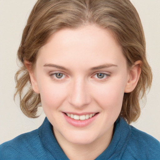 Joyful white young-adult female with medium  brown hair and blue eyes