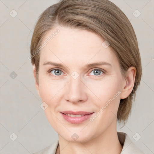 Joyful white young-adult female with medium  brown hair and blue eyes