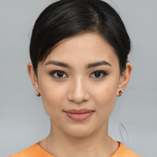 Joyful white young-adult female with medium  black hair and brown eyes