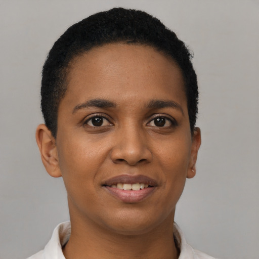 Joyful black young-adult female with short  brown hair and brown eyes