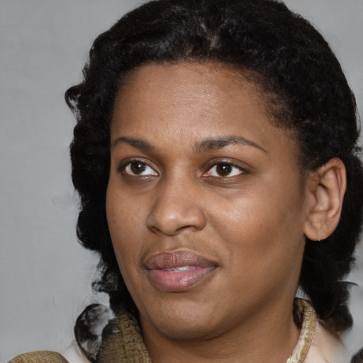 Joyful black young-adult female with medium  brown hair and brown eyes
