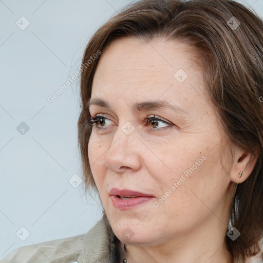 Joyful white adult female with medium  brown hair and grey eyes