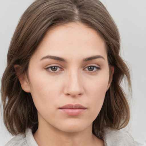 Neutral white young-adult female with medium  brown hair and grey eyes