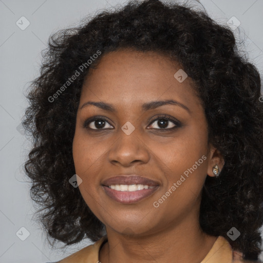 Joyful black young-adult female with long  black hair and brown eyes