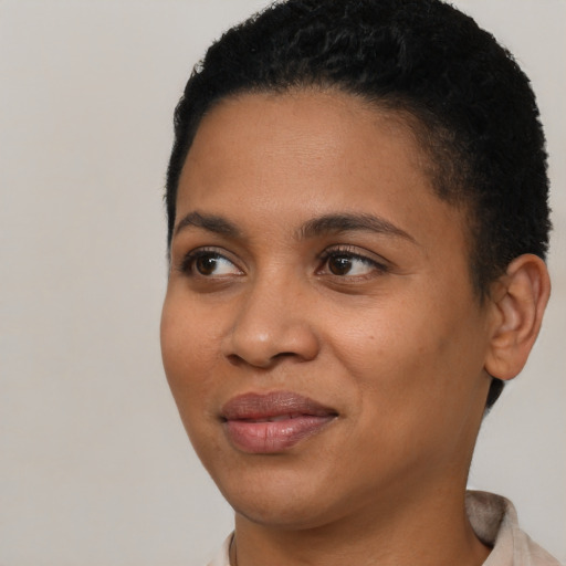 Joyful latino young-adult female with short  black hair and brown eyes