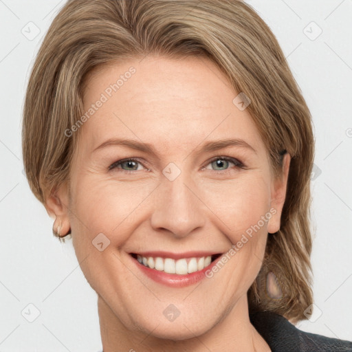 Joyful white adult female with medium  brown hair and grey eyes