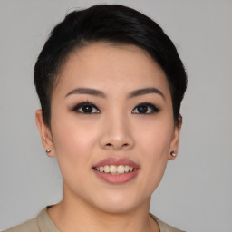 Joyful asian young-adult female with short  black hair and brown eyes