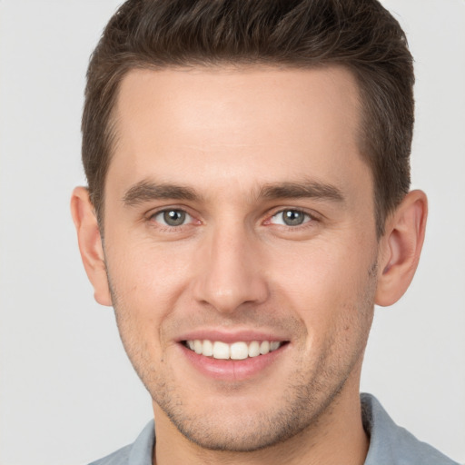 Joyful white young-adult male with short  brown hair and brown eyes