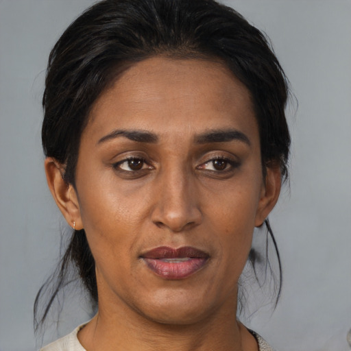 Joyful asian adult female with medium  brown hair and brown eyes