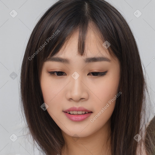 Joyful asian young-adult female with long  brown hair and brown eyes