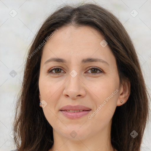 Joyful white adult female with long  brown hair and brown eyes