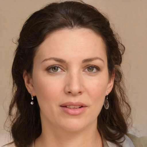 Joyful white young-adult female with medium  brown hair and green eyes