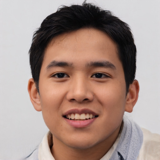 Joyful asian young-adult male with short  brown hair and brown eyes