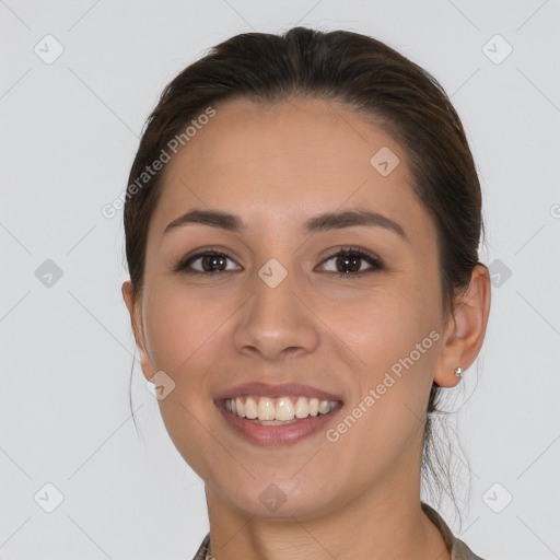 Joyful white young-adult female with long  brown hair and brown eyes