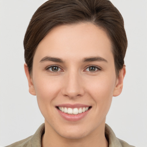 Joyful white young-adult female with short  brown hair and brown eyes