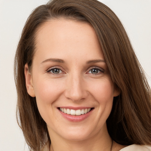 Joyful white young-adult female with long  brown hair and grey eyes