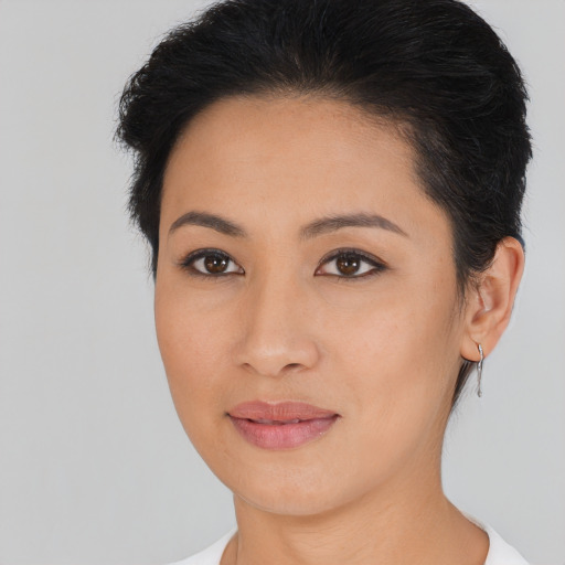Joyful asian young-adult female with short  brown hair and brown eyes