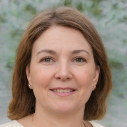 Joyful white adult female with medium  brown hair and grey eyes