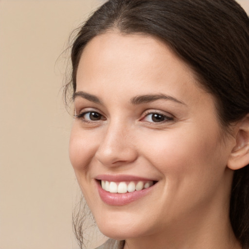 Joyful white young-adult female with long  brown hair and brown eyes