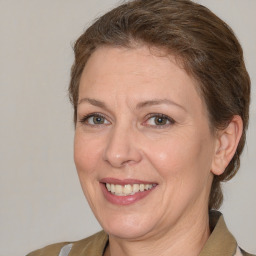 Joyful white adult female with medium  brown hair and grey eyes