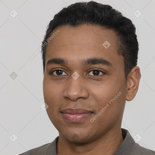 Joyful black young-adult male with short  black hair and brown eyes