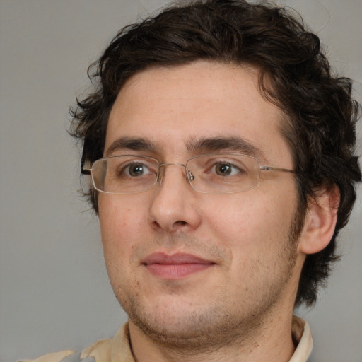 Joyful white adult male with medium  brown hair and brown eyes