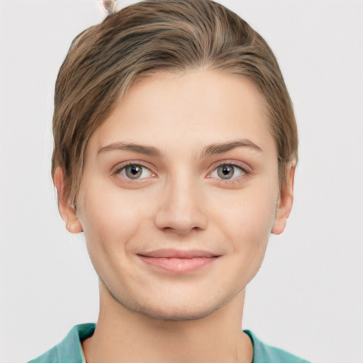 Joyful white young-adult female with short  brown hair and grey eyes