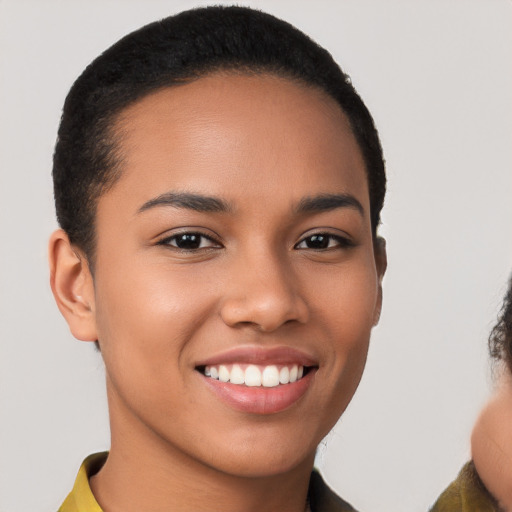 Joyful latino young-adult female with short  brown hair and brown eyes