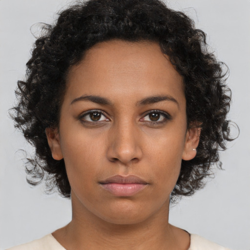 Neutral black young-adult female with medium  brown hair and brown eyes