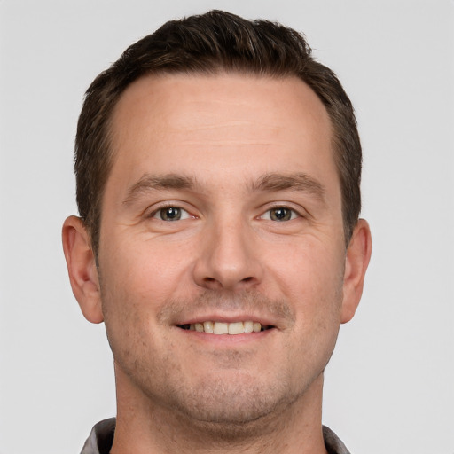 Joyful white adult male with short  brown hair and brown eyes