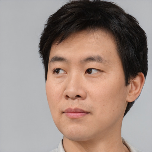 Neutral asian young-adult male with short  brown hair and brown eyes
