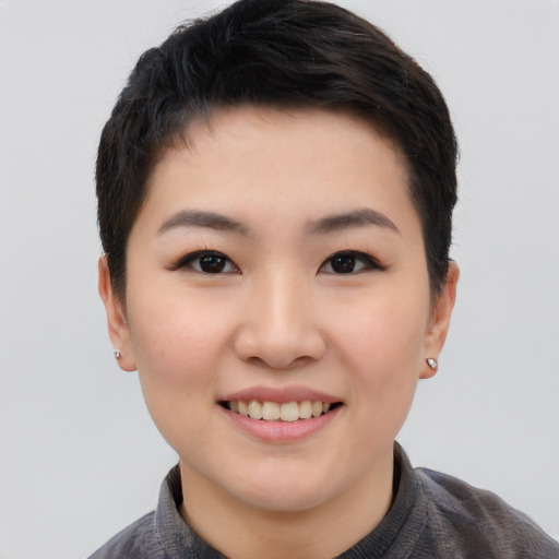 Joyful white young-adult female with short  black hair and brown eyes