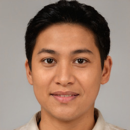 Joyful latino young-adult male with short  brown hair and brown eyes