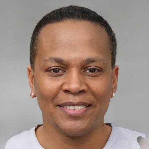 Joyful black adult male with short  brown hair and brown eyes