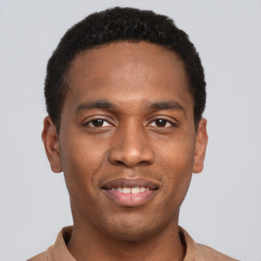 Joyful black young-adult male with short  black hair and brown eyes
