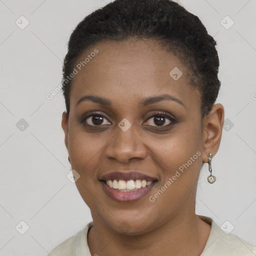 Joyful black young-adult female with short  brown hair and brown eyes