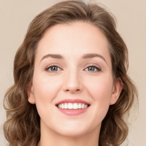 Joyful white young-adult female with long  brown hair and green eyes