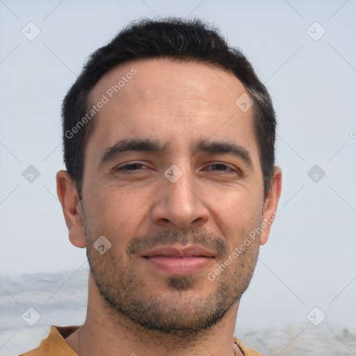 Joyful white adult male with short  black hair and brown eyes