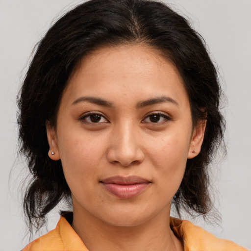 Joyful latino young-adult female with medium  brown hair and brown eyes