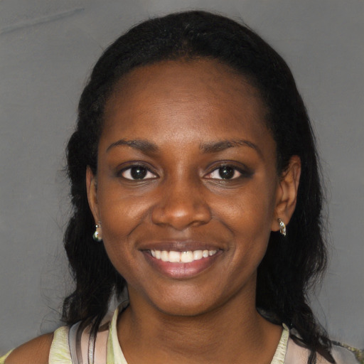 Joyful black young-adult female with medium  black hair and brown eyes