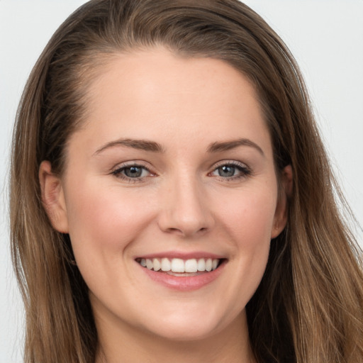 Joyful white young-adult female with long  brown hair and grey eyes