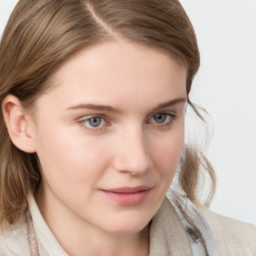 Joyful white young-adult female with medium  brown hair and blue eyes