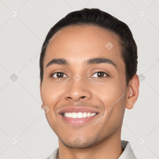 Joyful latino young-adult male with short  black hair and brown eyes