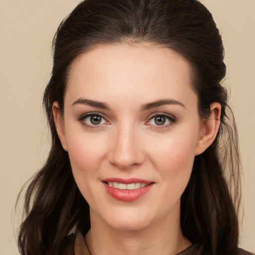 Joyful white young-adult female with long  brown hair and brown eyes